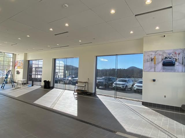 Car dealership showroom with tinted glass walls